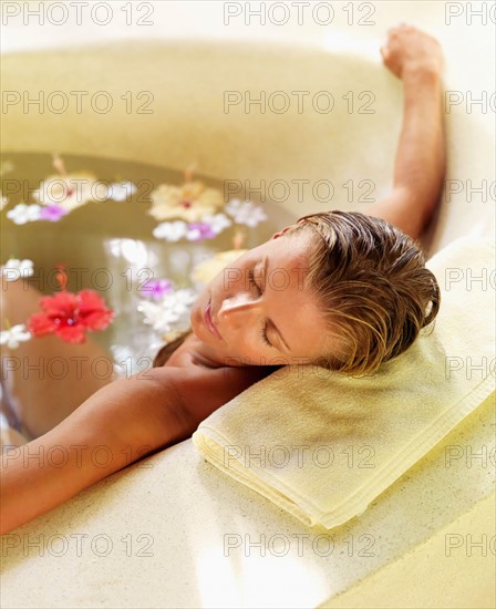 Woman relaxing in bathtub