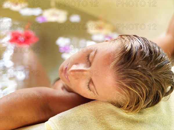 Woman relaxing in bathtub