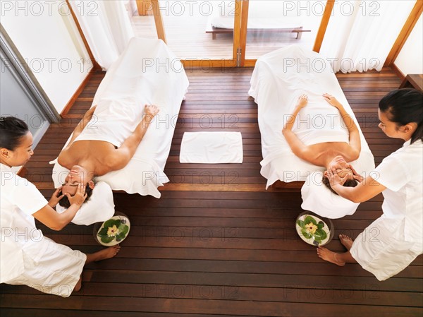 Couple getting massage in spa