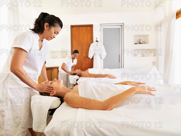 Two people getting massage in spa