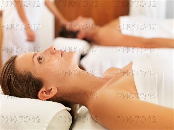 Two people getting massage in spa