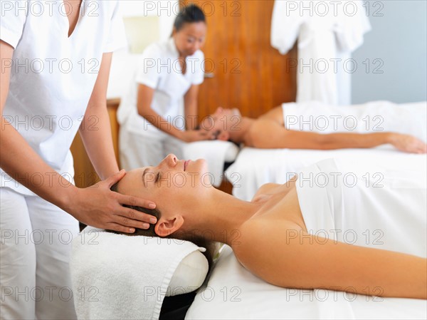 Two people getting massage in spa