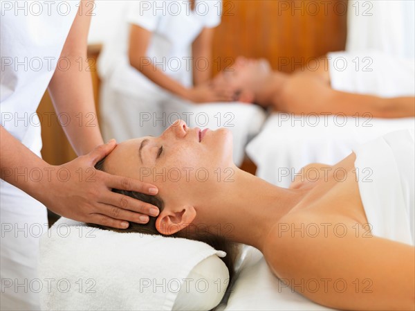 Two people getting massage in spa