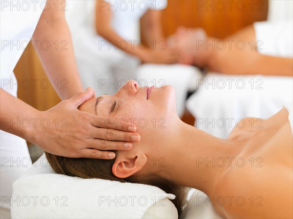 Two people getting massage in spa