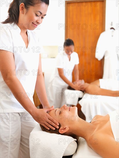 Two people getting massage in spa