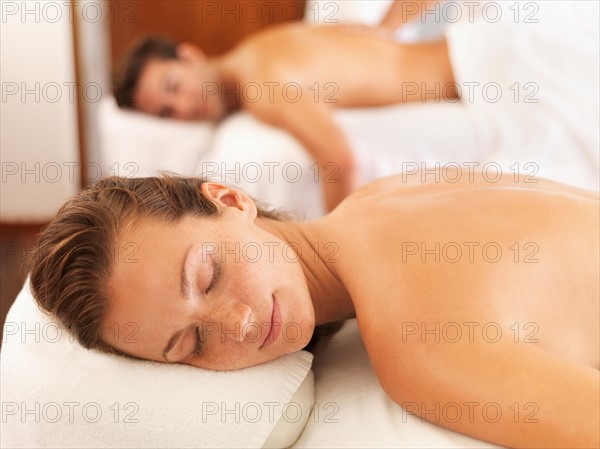 Two people getting massage in spa