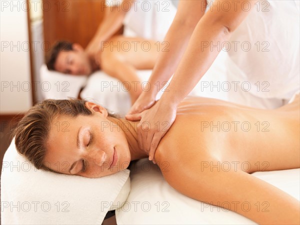 Two people getting massage in spa