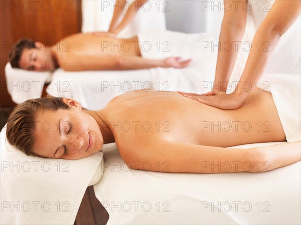 Two people getting massage in spa