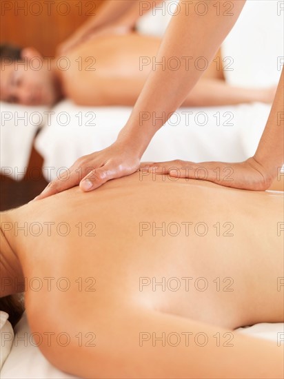 Two people getting massage in spa