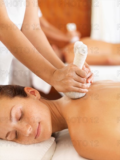 Two people getting massage in spa