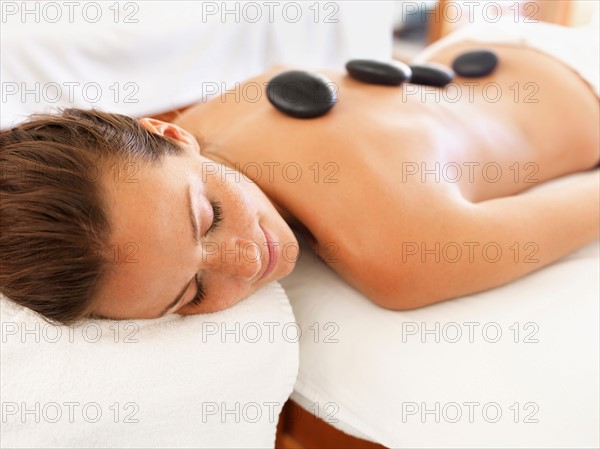 Woman getting lastone therapy in spa