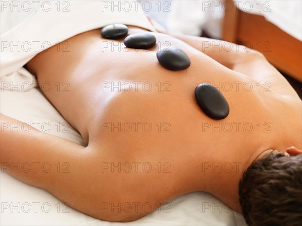 Man getting lastone therapy in spa