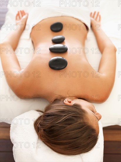 Woman getting lastone therapy in spa