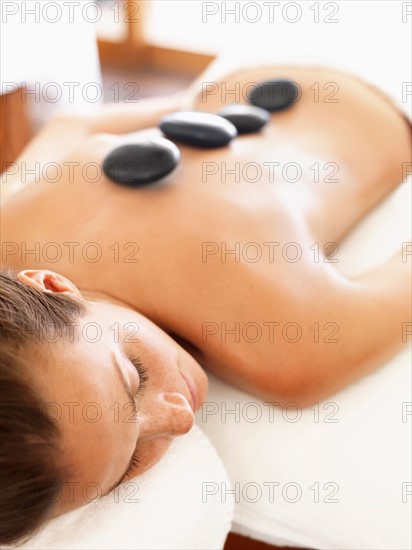 Woman getting lastone therapy in spa