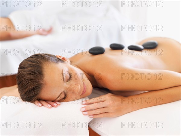 Woman getting lastone therapy in spa