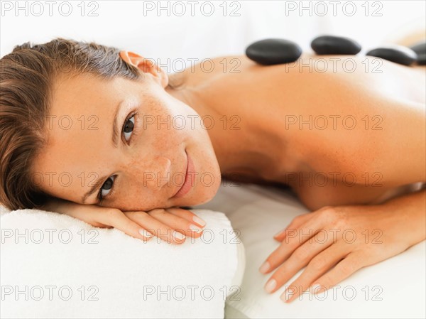 Woman relaxing while getting stone massage