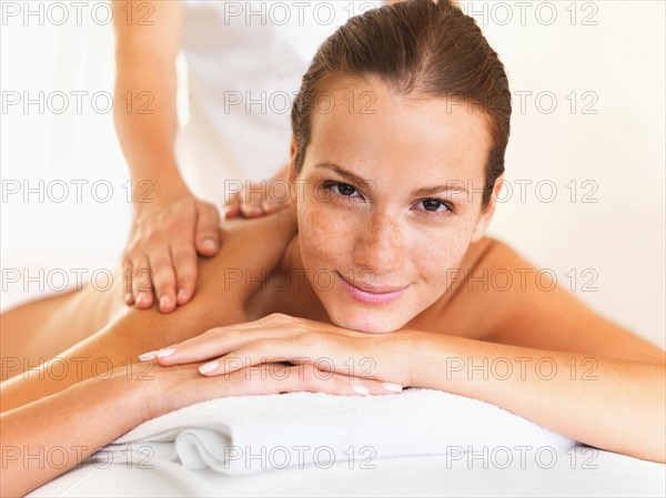 Woman relaxing while getting massage