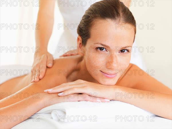 Woman relaxing while getting massage