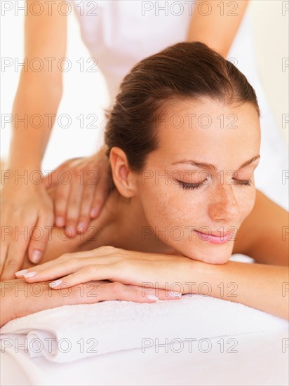Woman relaxing while getting massage