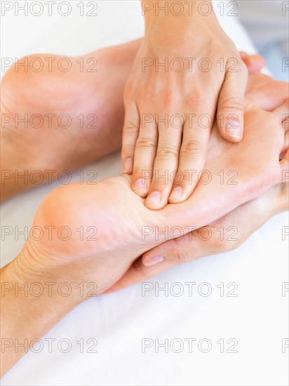 Hand massaging feet