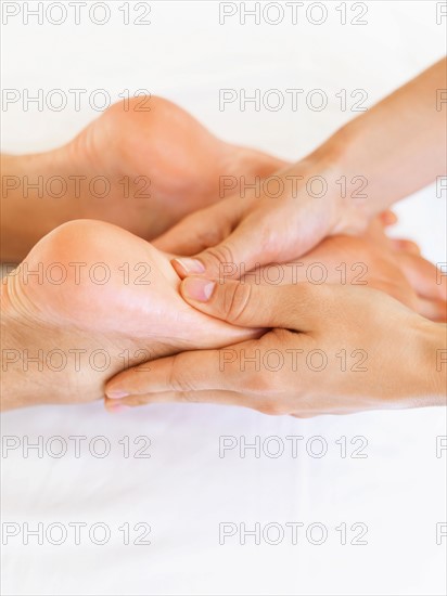 Hand massaging feet