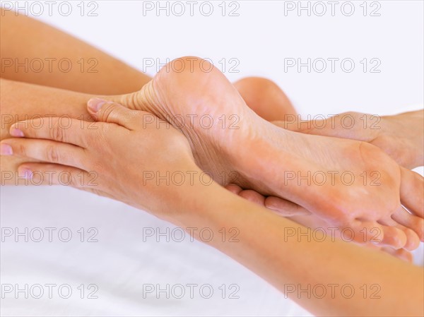 Hand massaging feet