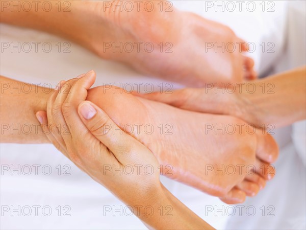 Hand massaging feet