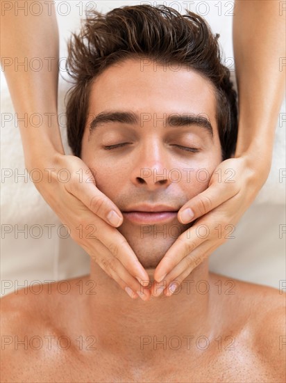 Man receiving massage in spa