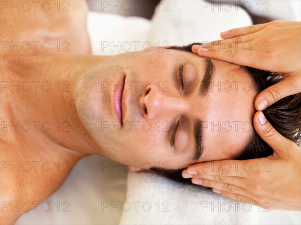 Man receiving massage in spa