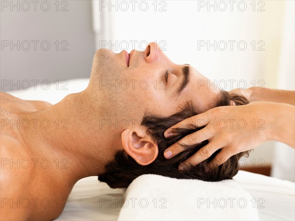 Man receiving massage in spa