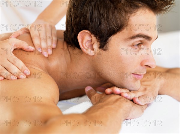 Man receiving massage in spa