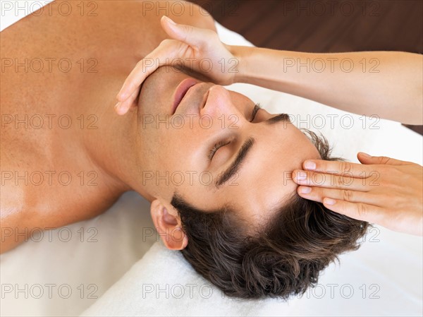 Man receiving massage in spa