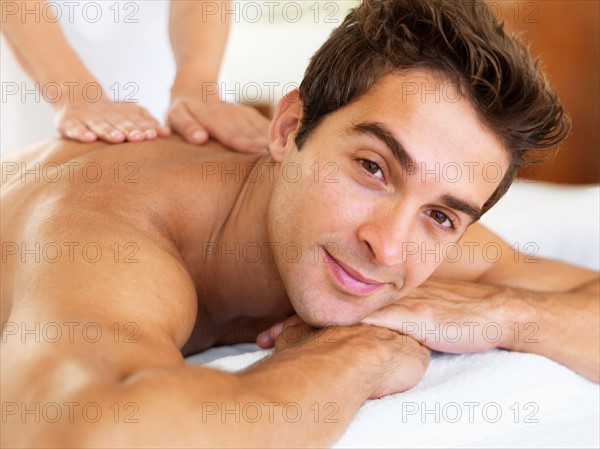 Man receiving massage in spa