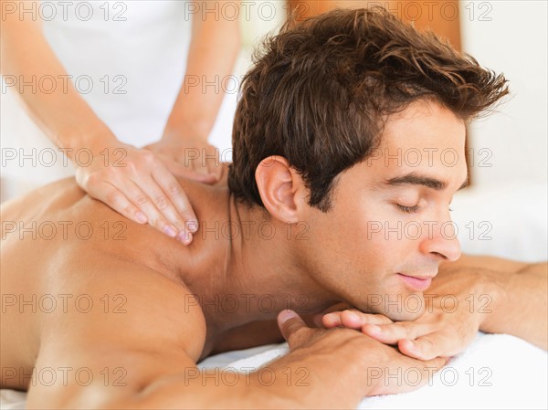 Man receiving massage in spa