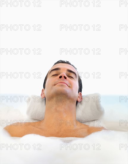 Man relaxing in bathtub