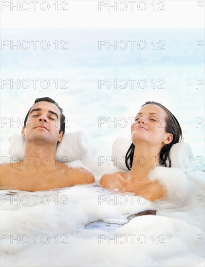 Couple relaxing in bathtub