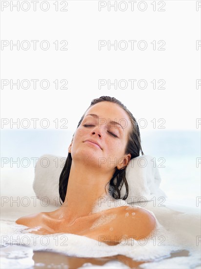 Woman relaxing in bathtub