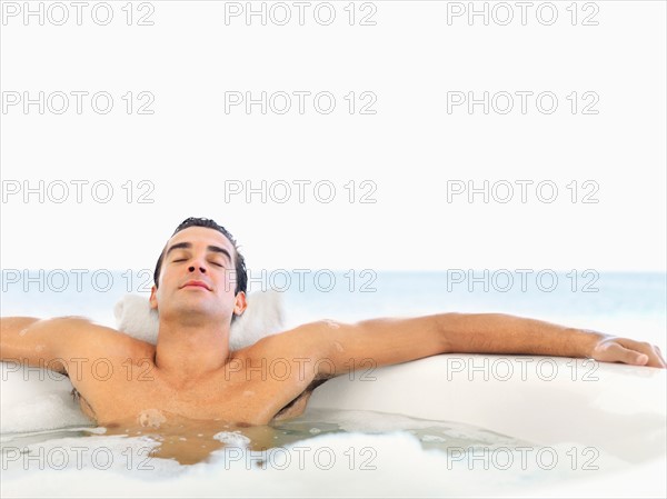 Man relaxing in bathtub