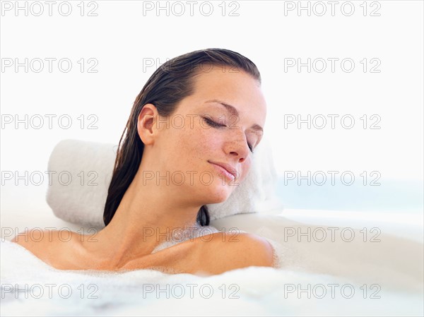 Woman relaxing in bathtub