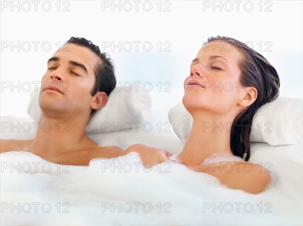 Couple relaxing in bathtub