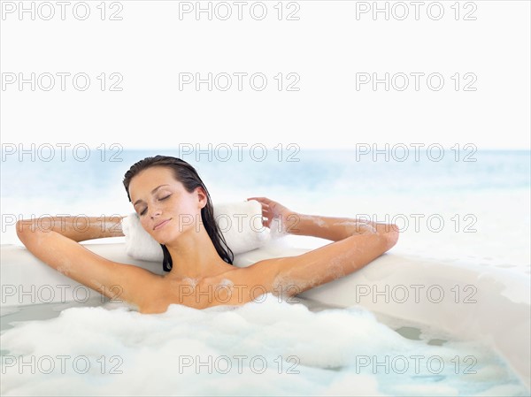 Woman relaxing in bathtub