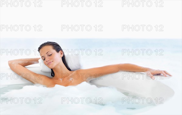 Woman relaxing in bathtub