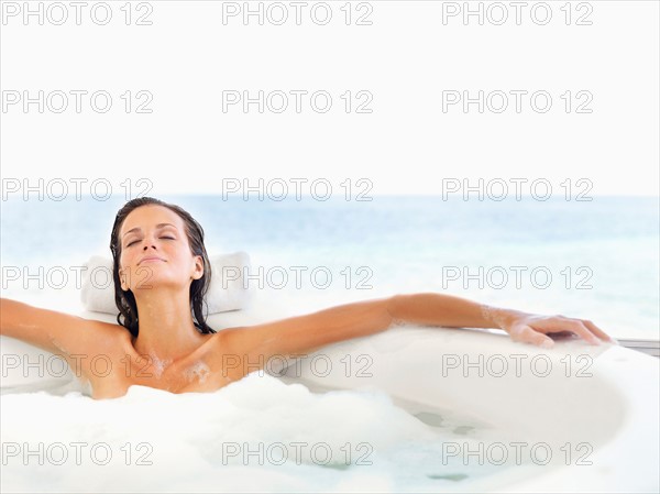 Woman relaxing in bathtub