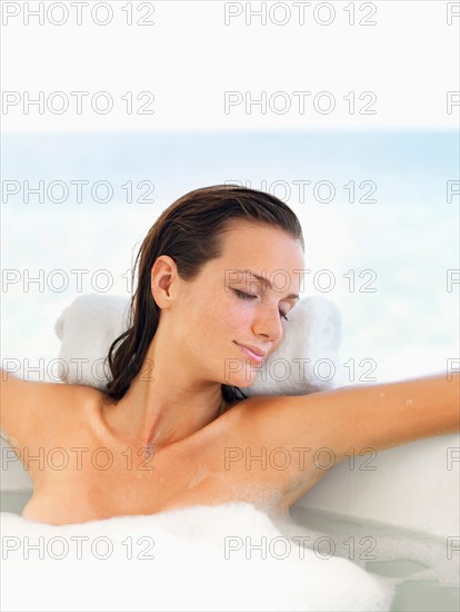 Woman relaxing in bathtub