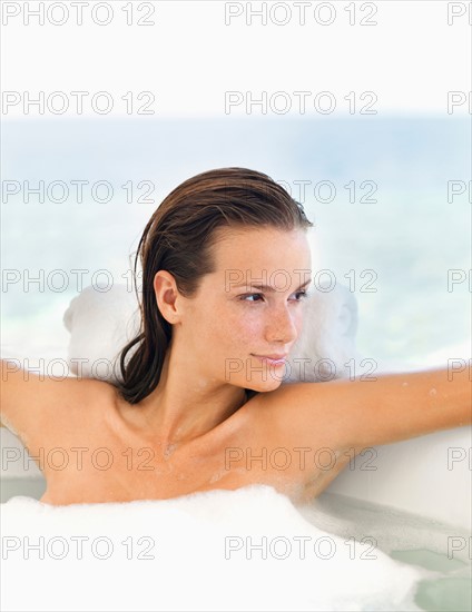 Woman relaxing in bathtub