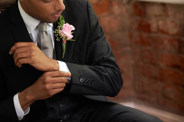 Bridegroom adjusting cuff