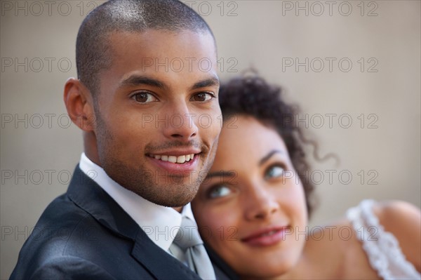 Portrait of newly wed couple, focus on groom