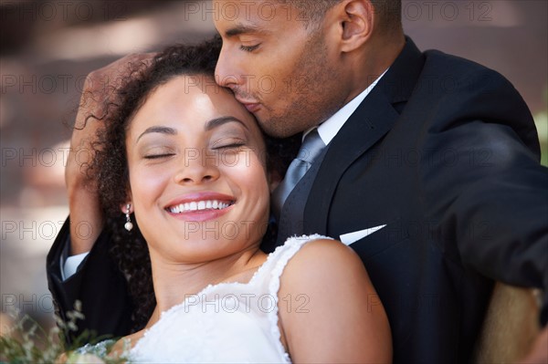 Groom kissing bridge