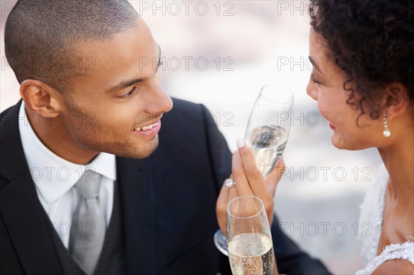 Newly wed couple drinking champagne