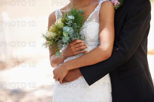 Newlywed couple embracing